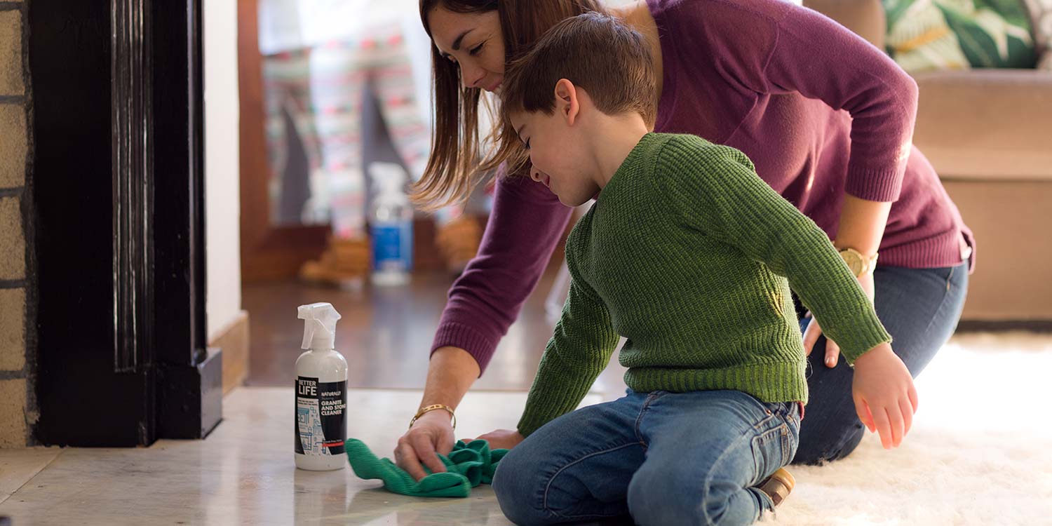 A mother and son cleaning a floor with Better Life's Graninte and Stone Cleaner