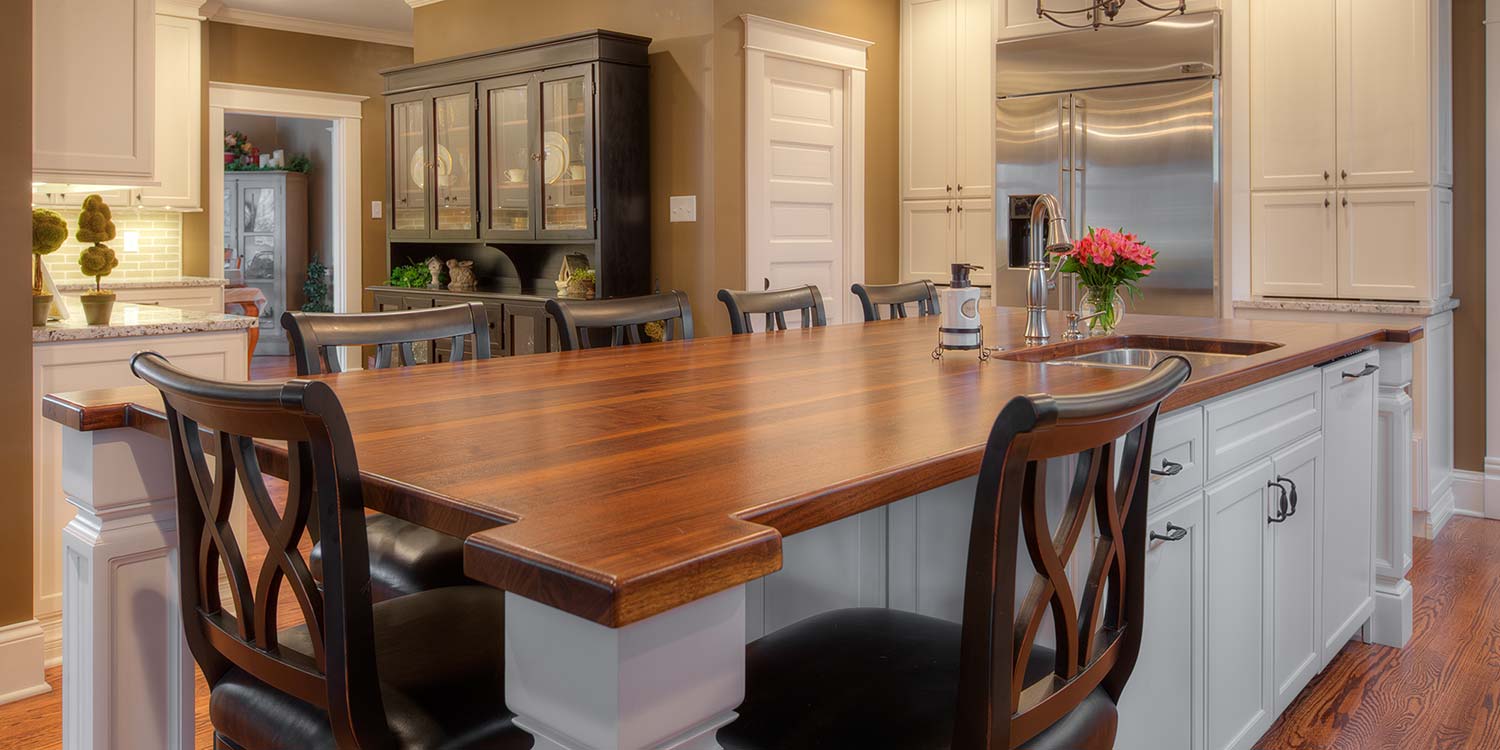 An image of a beautiful wood countertop placed inside of a complete kitchen